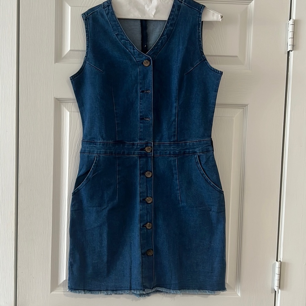 New knee length denim dress with button closure in front.